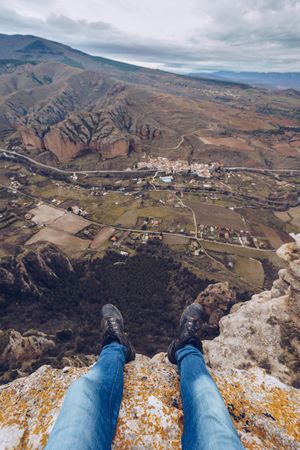 Tourist resting on edge of cliff