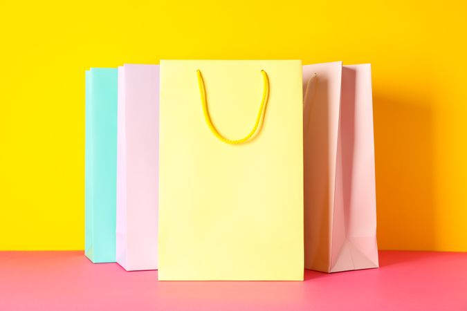 Color paper bags on multicolor background, space for text