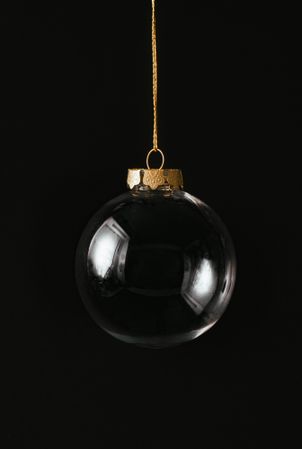 Christmas dark background with clear bauble decoration