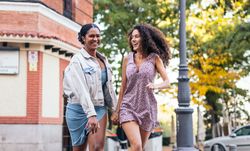 Lesbian couple walking down the street, holding hands.