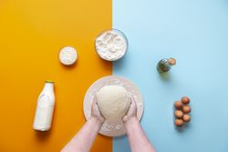 Baking flat lay with woman holding dough