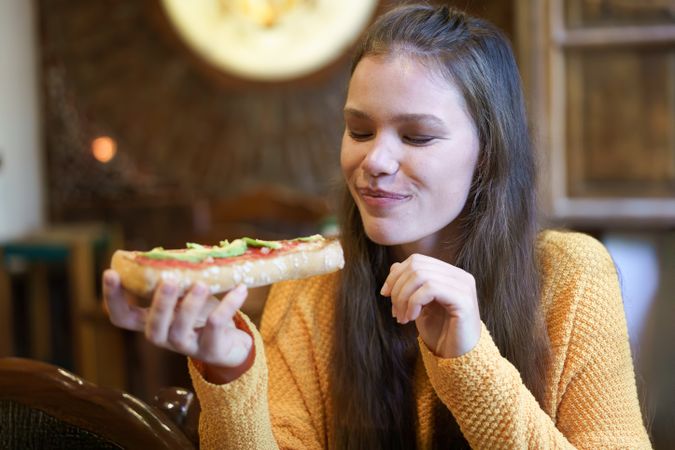 Delightfully savoring a freshly made sandwich while relaxing in a cozy and warm setting