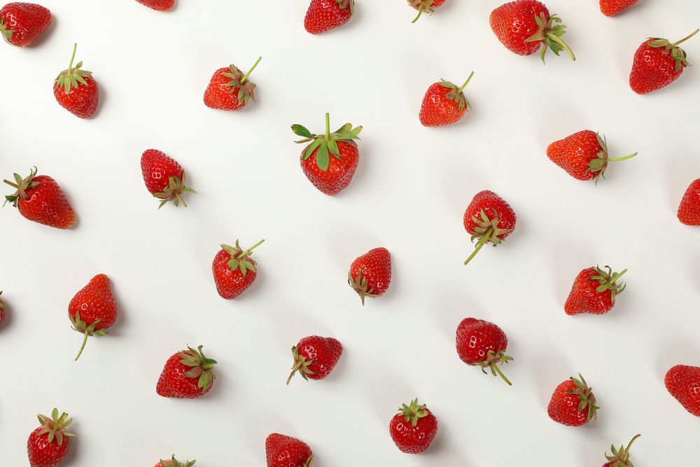 Flat lay with tasty strawberry on neutral background, top view. Summer berry