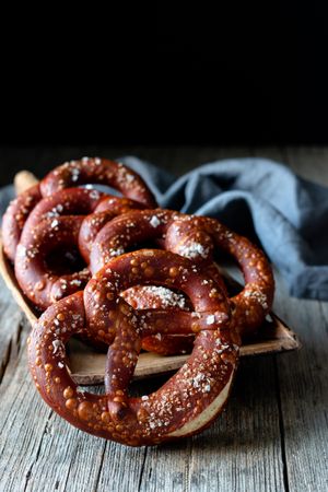 Delicious baked pretzels on wooden table
