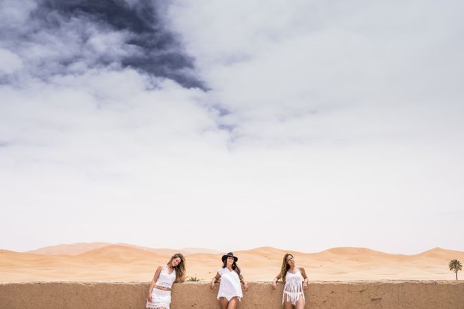 Women in white on desert landscape