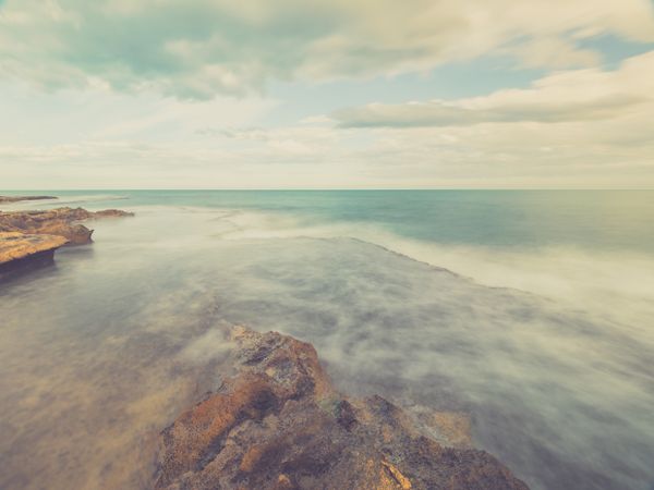 Rocky seashore under blue sky
