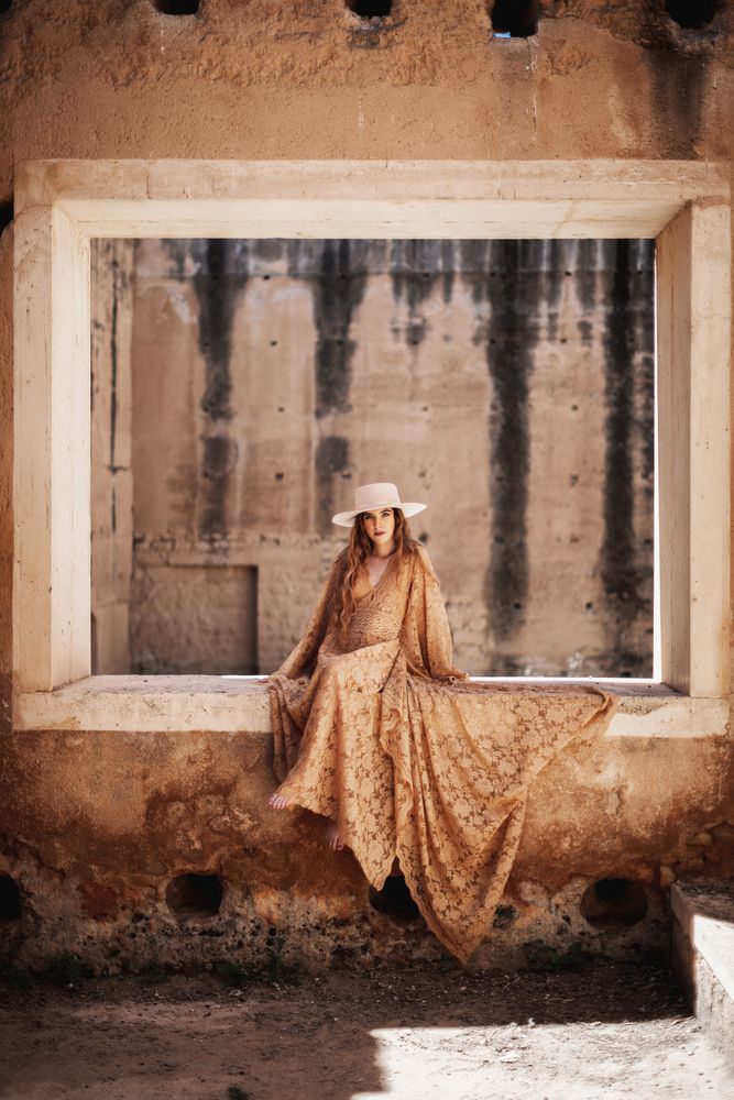 Elegant female in long dress on window