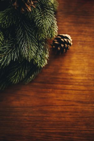 Advent wreath and pine cone on wooden background