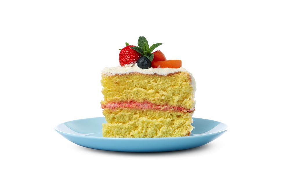 Plate with berry cream cake isolated on plain background