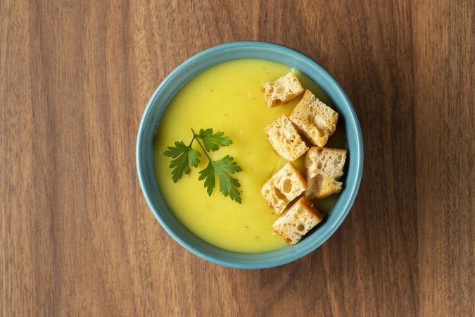 Bowl with onion soup and croutons on the table.