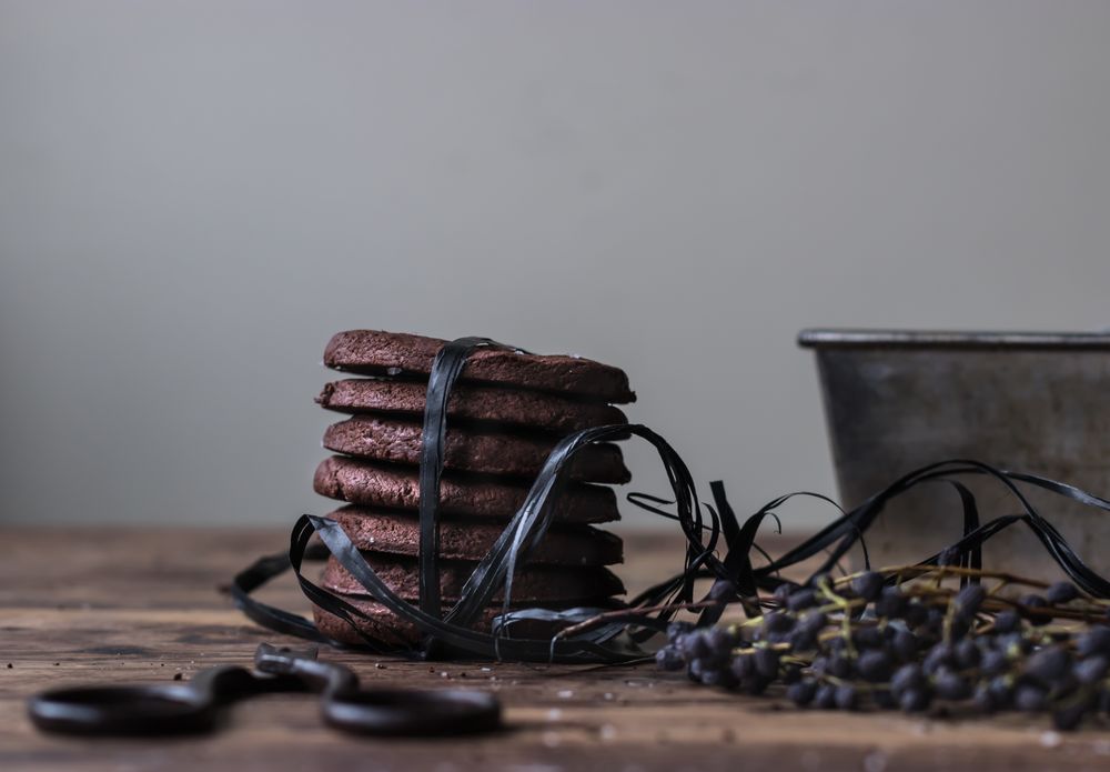 Stack of chocolate cookies tied with black ribbon