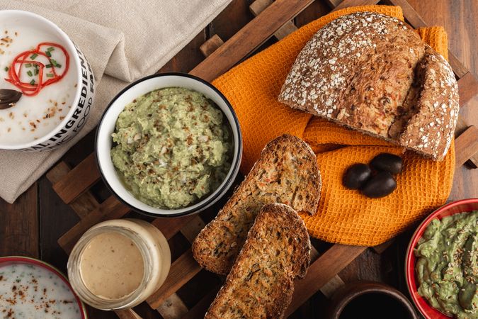 Tasty sauces decorated with sesame seeds and lush bread