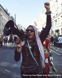 London, England, United Kingdom - March 19 2022: Black woman with loudspeaker and raised fist 5onkQ0
