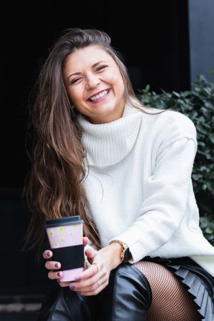 Smiling woman with cup of coffee
