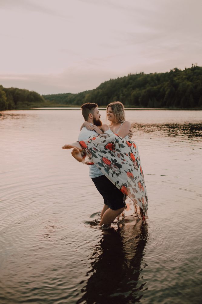Loving couple standing ankle deep in water on beach