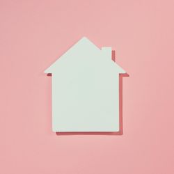 Paper house on pink background
