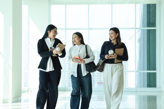 Happy Three Asian College Student Classmate walking on Campuss Hallway