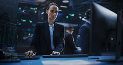 Portrait of a Female Stockbroker Working in an International Stock Exchange Office.