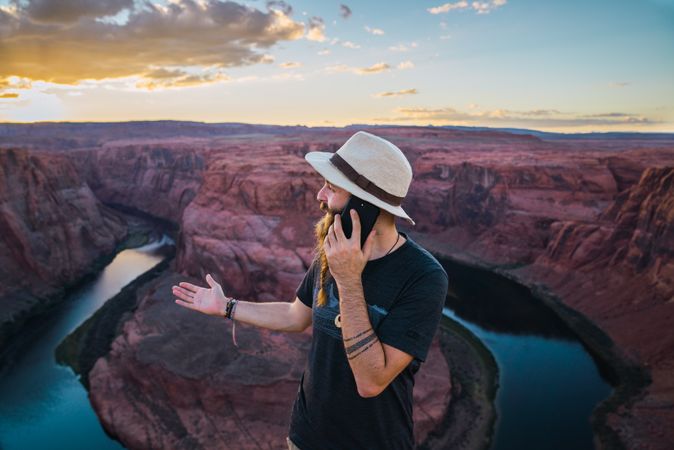 Traveler on the mobile phone near canyon