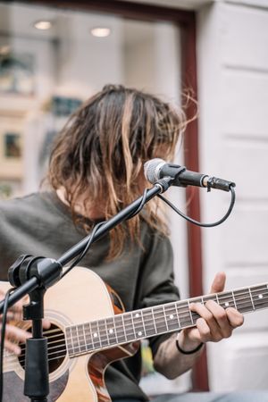 Faceless male musician performing in the street