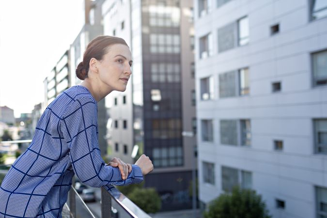 Smiling businesswoman standing on balcony