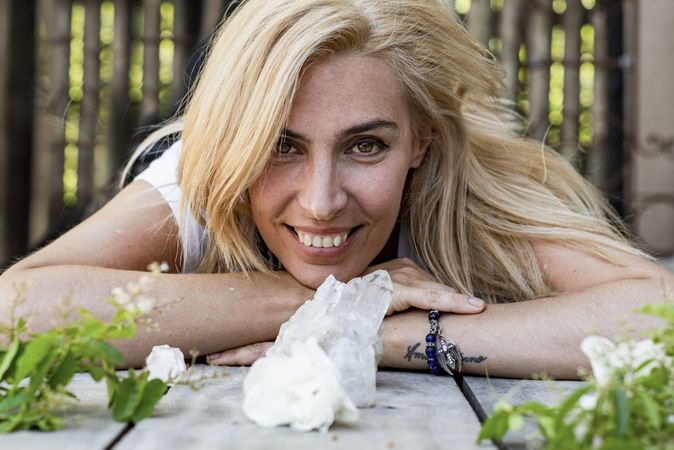 Portrait of a woman lying on the floor while looking at camera