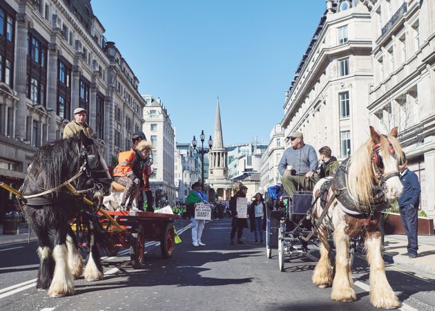 London, England, United Kingdom - March 19 2022: Two horse and buggy’s going through London