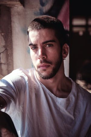 Serious man in neglected building