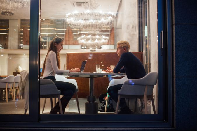 Man and woman having a casual study session in a restaurant
