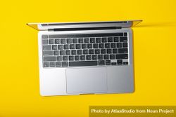 Top view of open laptop on yellow desk 42mem5