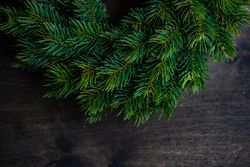 Close up of fir branch wreath on wooden table