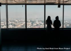 Back of two women enjoying view of Mexico City on hazy day 0V1nGb