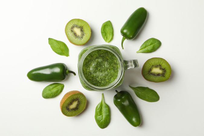 Kiwi, spinach, pepper and smoothie on blank background