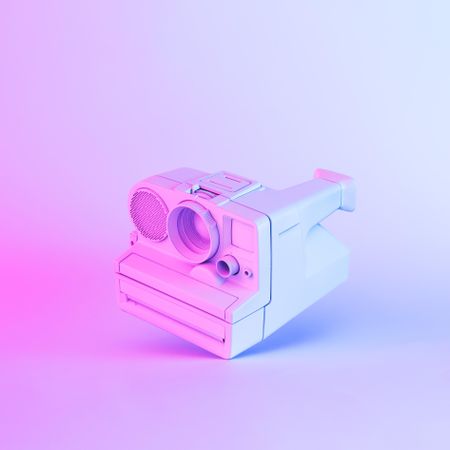 Vintage camera painted in light colored paint with bold gradient purple and blue holographic