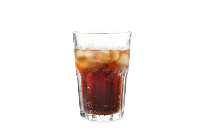 Glass of cola with ice isolated on blank background