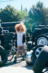 Full length fashion photo of young woman with afro and casual fashion outfit