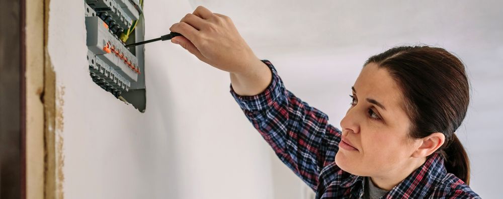 Electrician working on the distribution panel of a house
