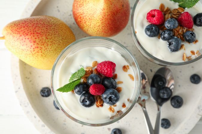 Parfaits and pears on wooden table, space for text