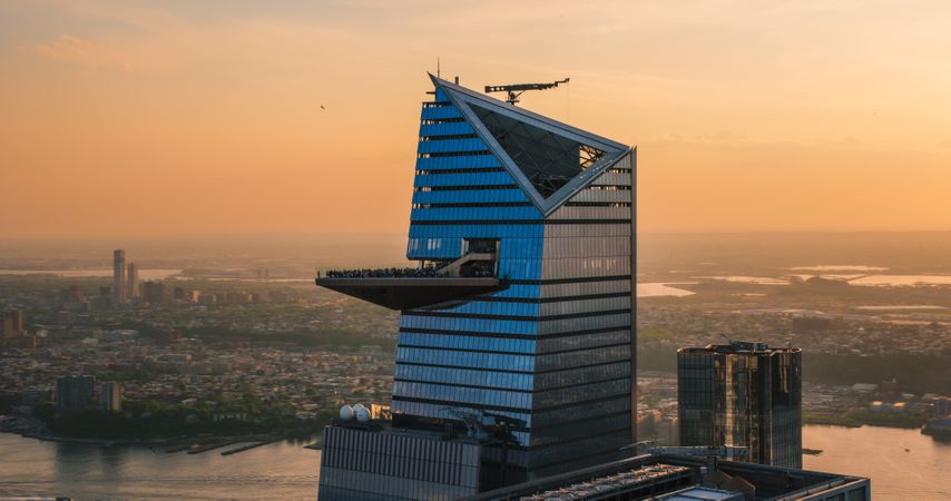Panorama Around the 30 Hudson Yards Skyscraper in New York City, USA. Aerial Photo with a Modern Skyscraper with Crowded Observation Balcony. Travelers Relishing the Panoramic Summer View