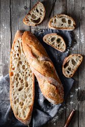 Fresh baguettes on checkered towel