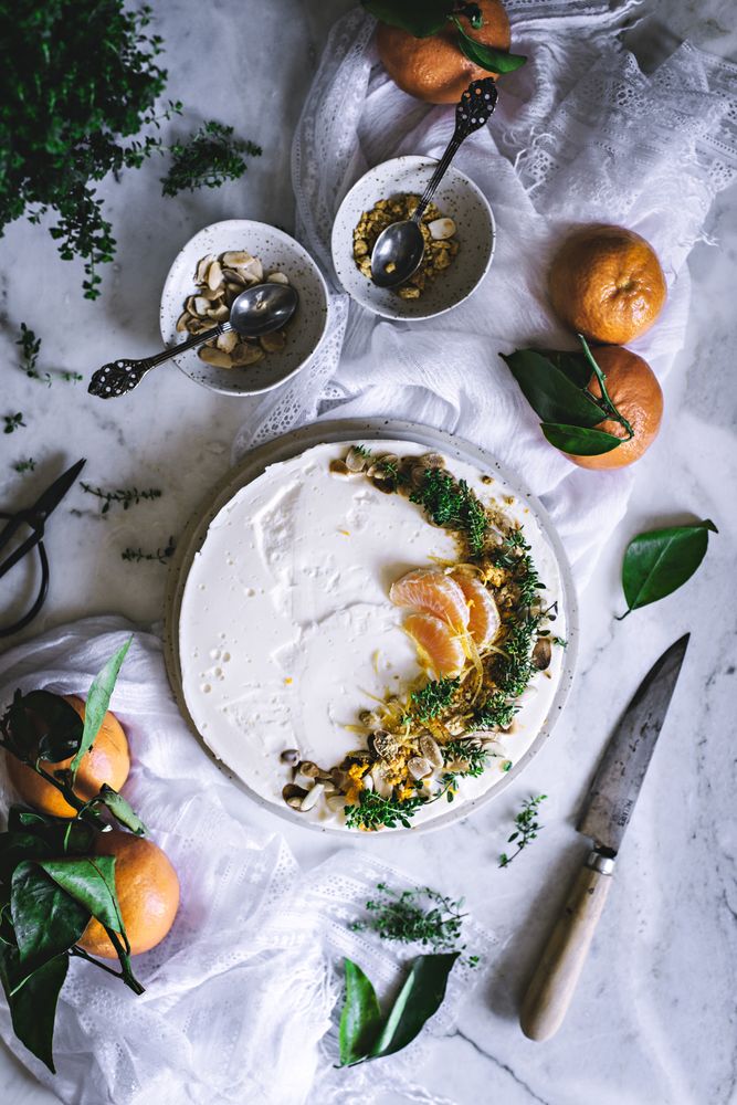 Tangerine cake decorated with whipped cream and sliced citrus
