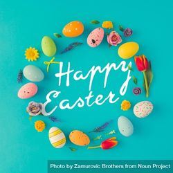 Easter eggs wreath on bright blue background with the words “Happy Easter” 42JRq4