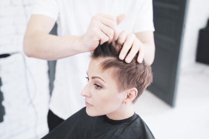 Hairdresser combing the woman's fingers