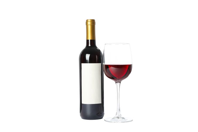 Bottle and glass with red wine isolated on blank background