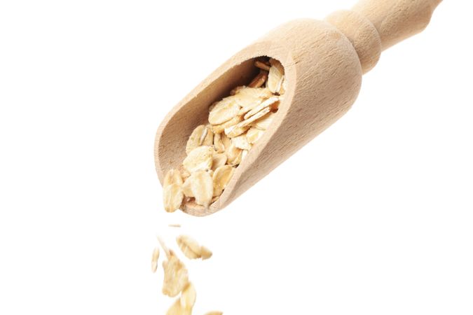 Scoop with oatmeal flakes isolated on plain background