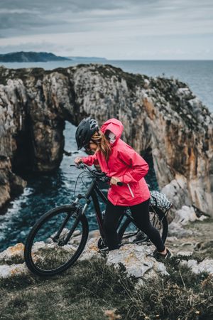Female bicyclist on rocks