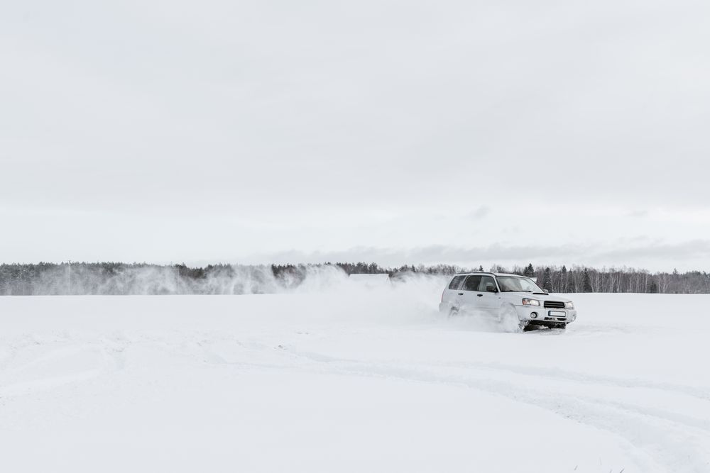 Car driving on snow field