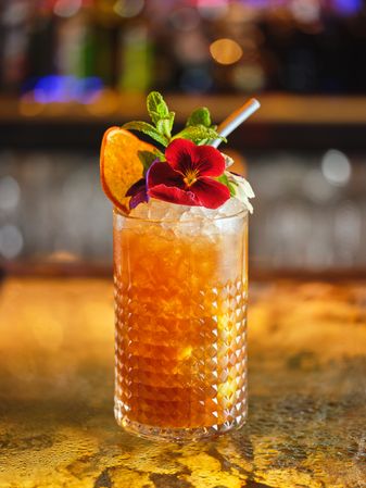 Glass of refreshing cocktail in bar