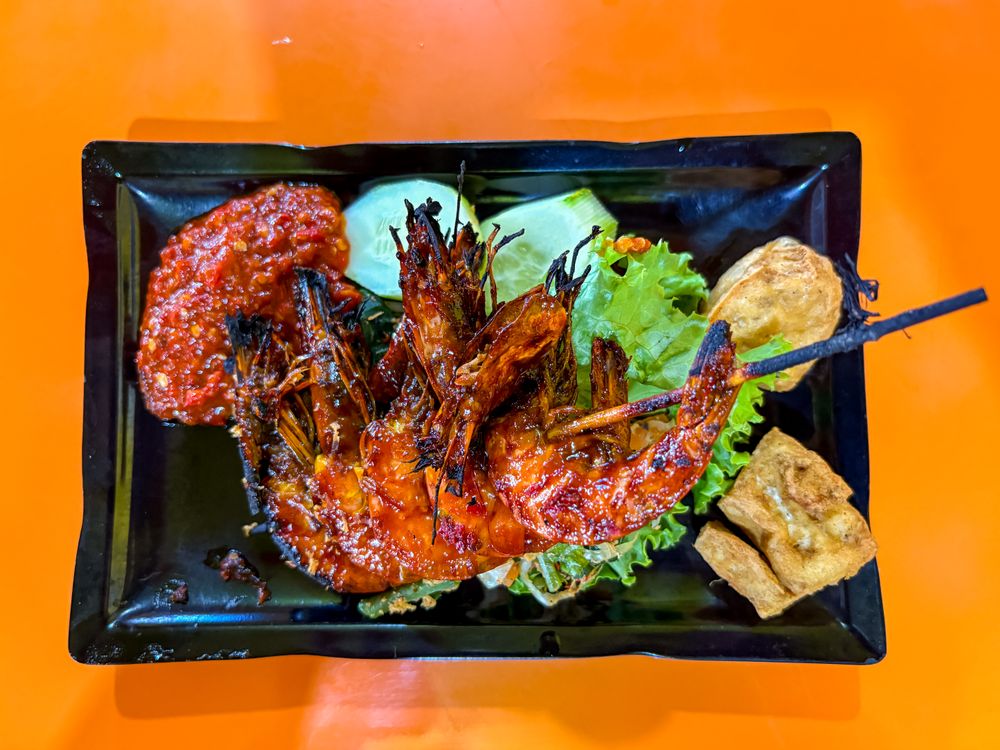 top view of Grilled Prawns Served with Vegetables, Chili Sauce, and Fried Tofu