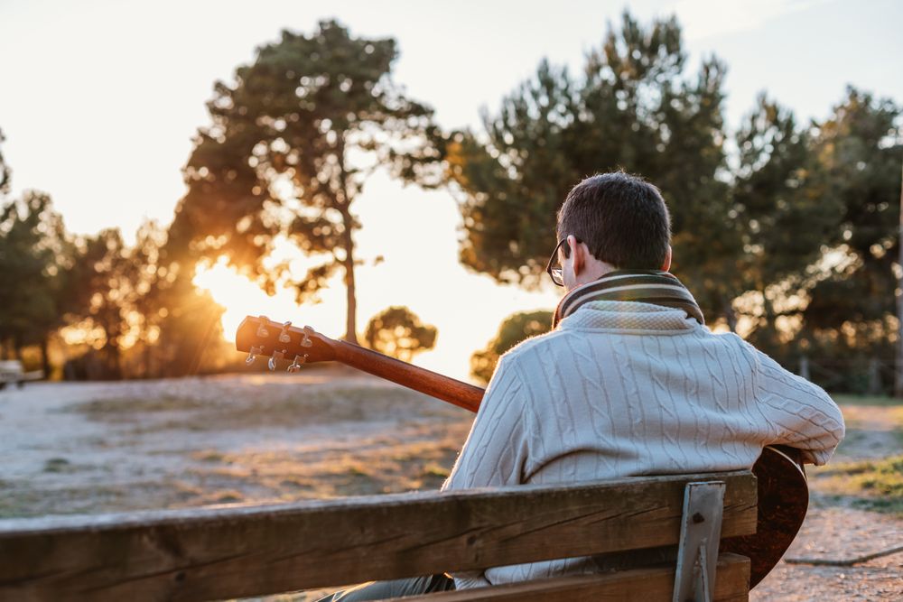 Man playing the guitar on the outside
